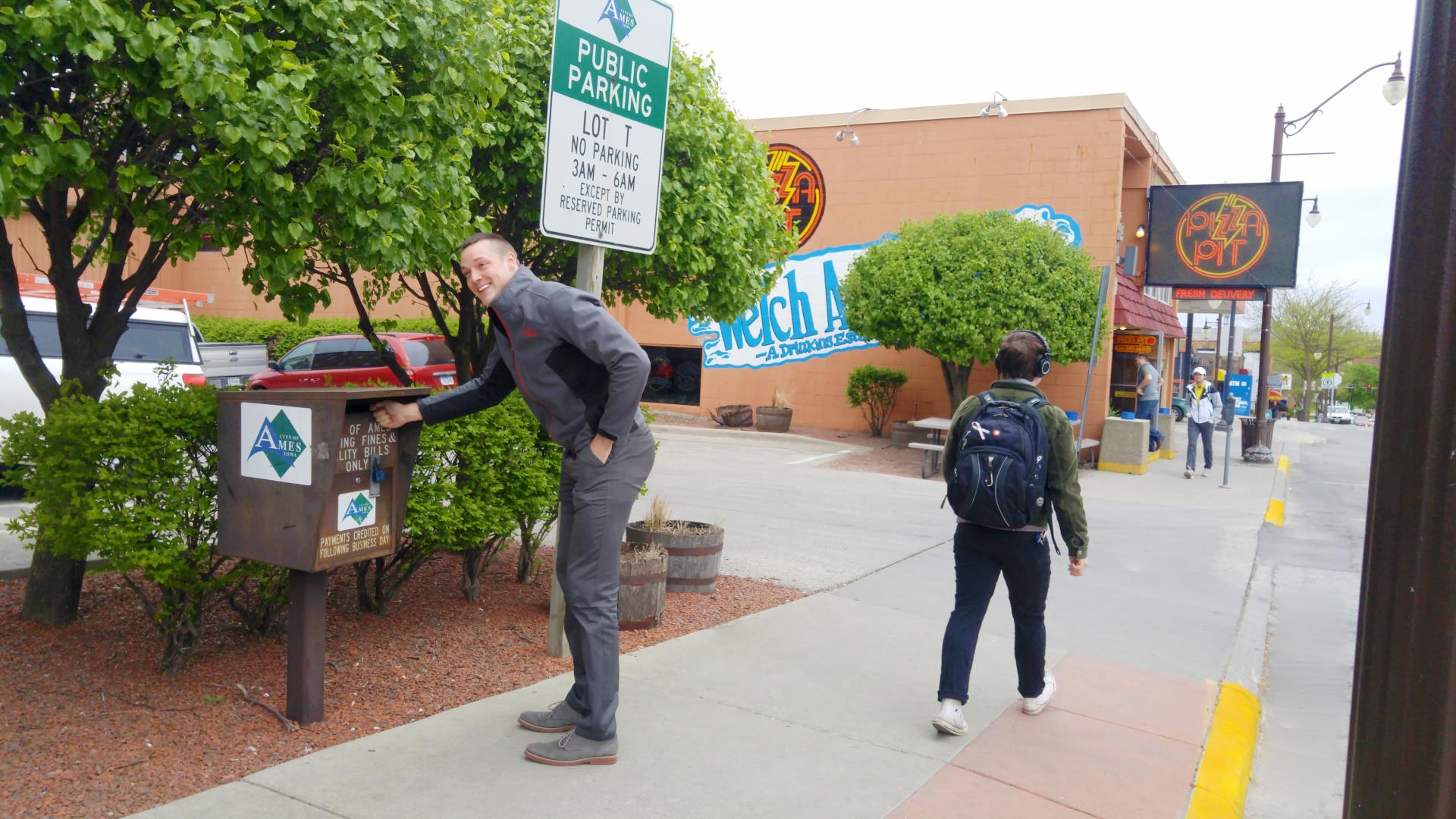 Utility Box Student Smiling while puting payment in box